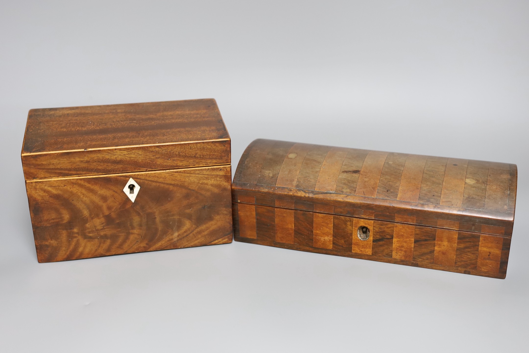A George III inlaid mahogany tea caddy, a Victorian satinwood and rosewood domed topped glove box, a burr wood circular tray, a George III inlaid mahogany domed topped easel mirror and a pair of turned hardwood cups
